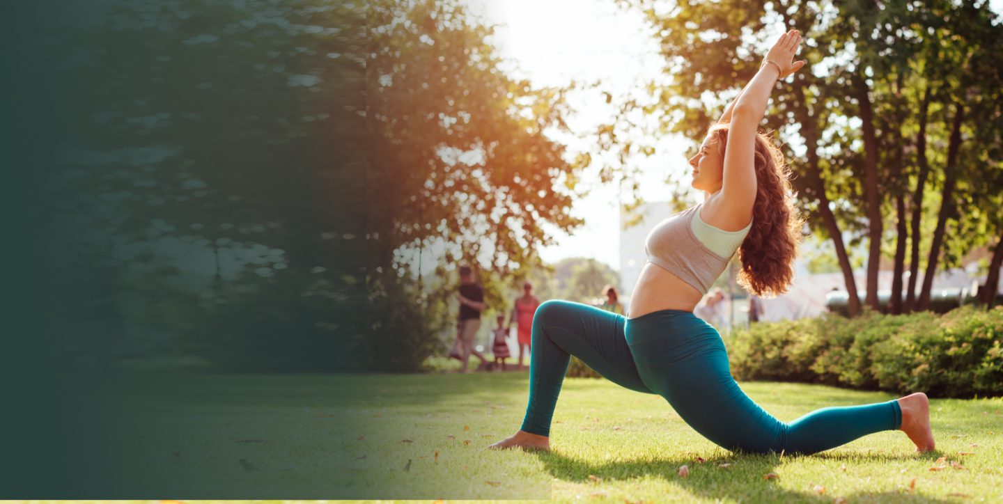 Image of a woman doing yoga in a park.